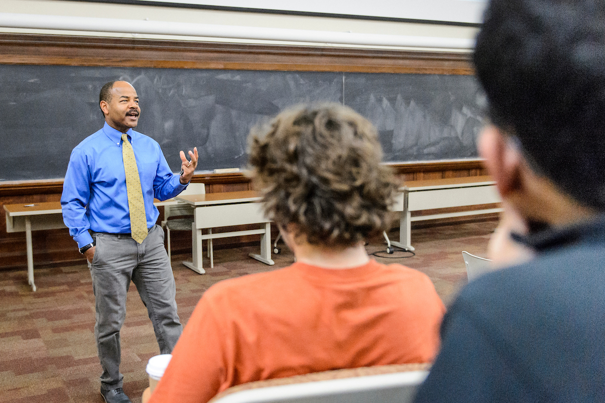Eric Wilcots, professor stands in front of class lecturing.