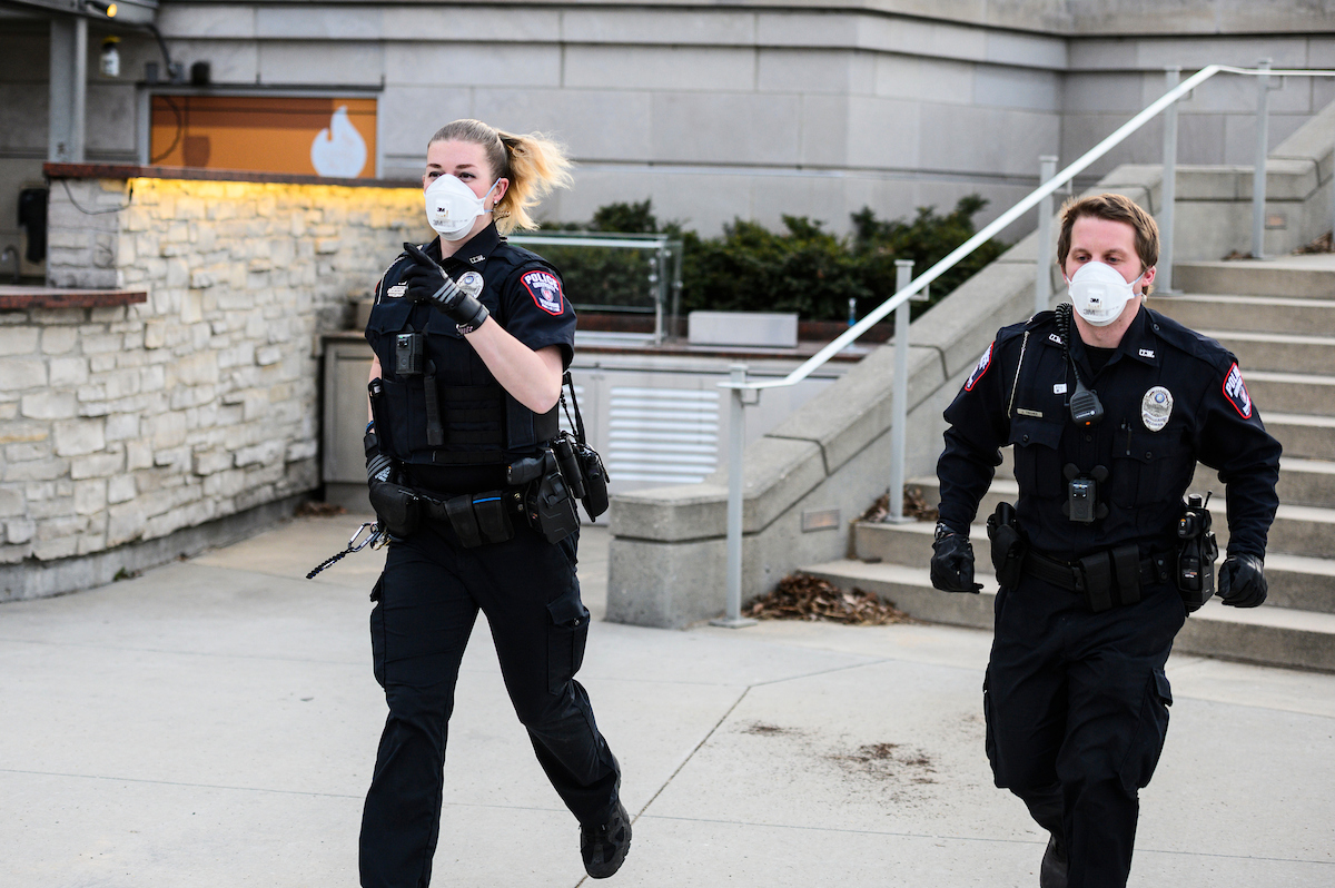 Wearing N95 medical masks, two UW Police Department officers respond to an incident on campus