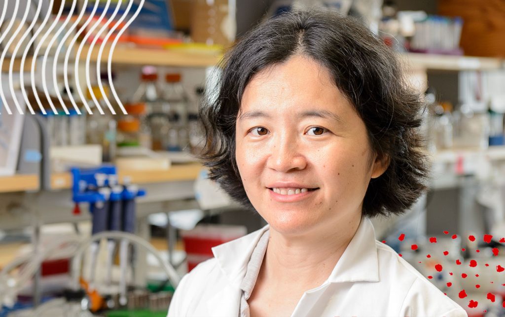 A faculty member smiling at the camera with UW-Madison brand digital icons in the background.